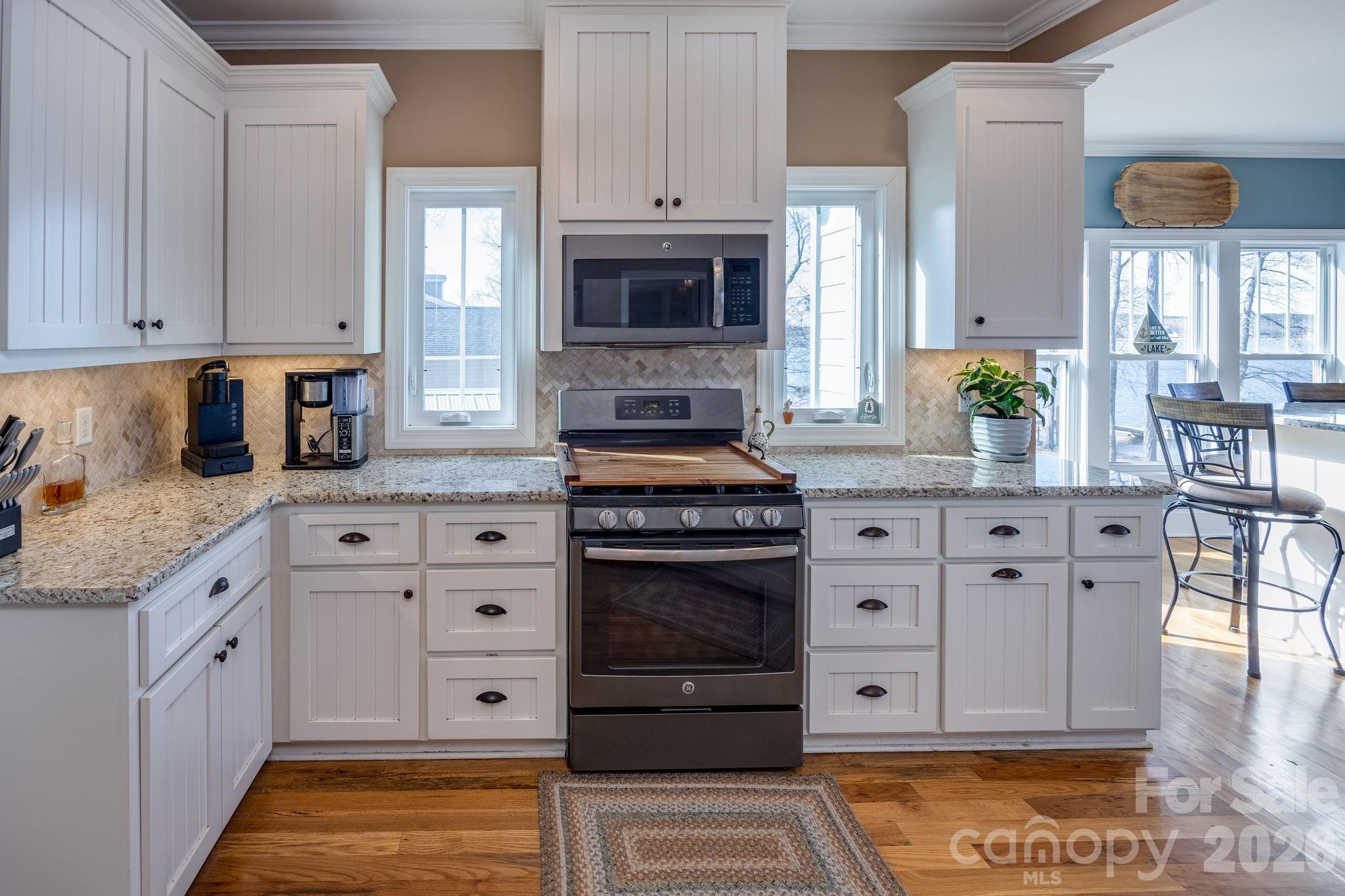2583 Rockbridge Road Ridgeway, SC 29130 - Photo 13 of 48 a kitchen with stainless steel appliances granite countertop a stove a sink and a white cabinets