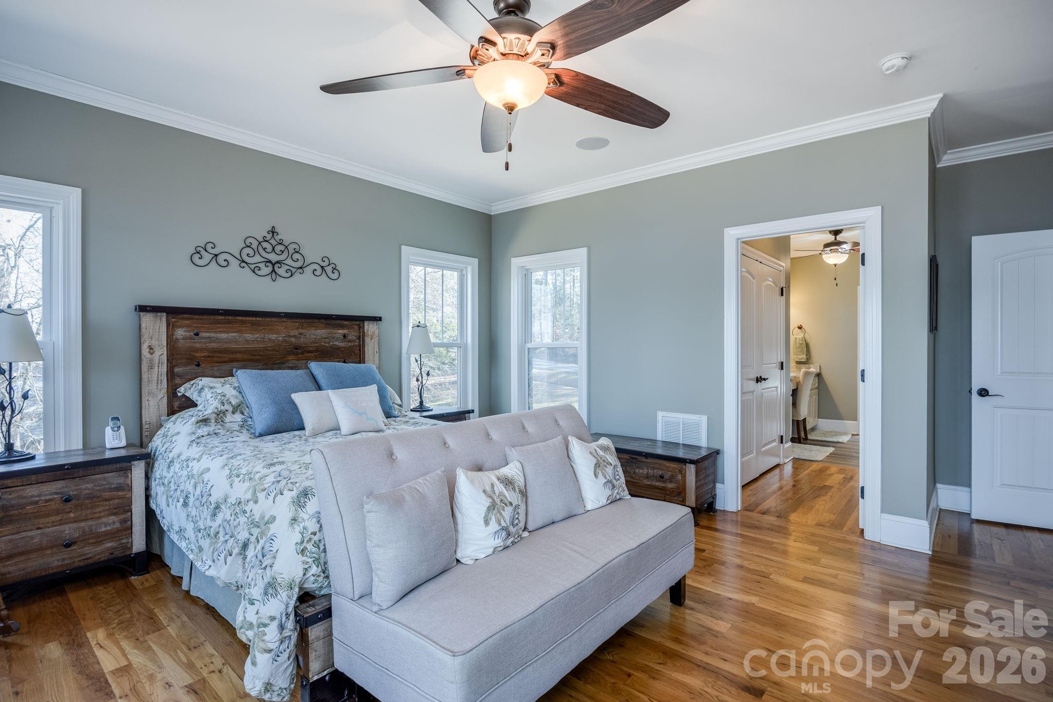 2583 Rockbridge Road Ridgeway, SC 29130 - Photo 22 of 48 a spacious bedroom with a bed chandelier and a window