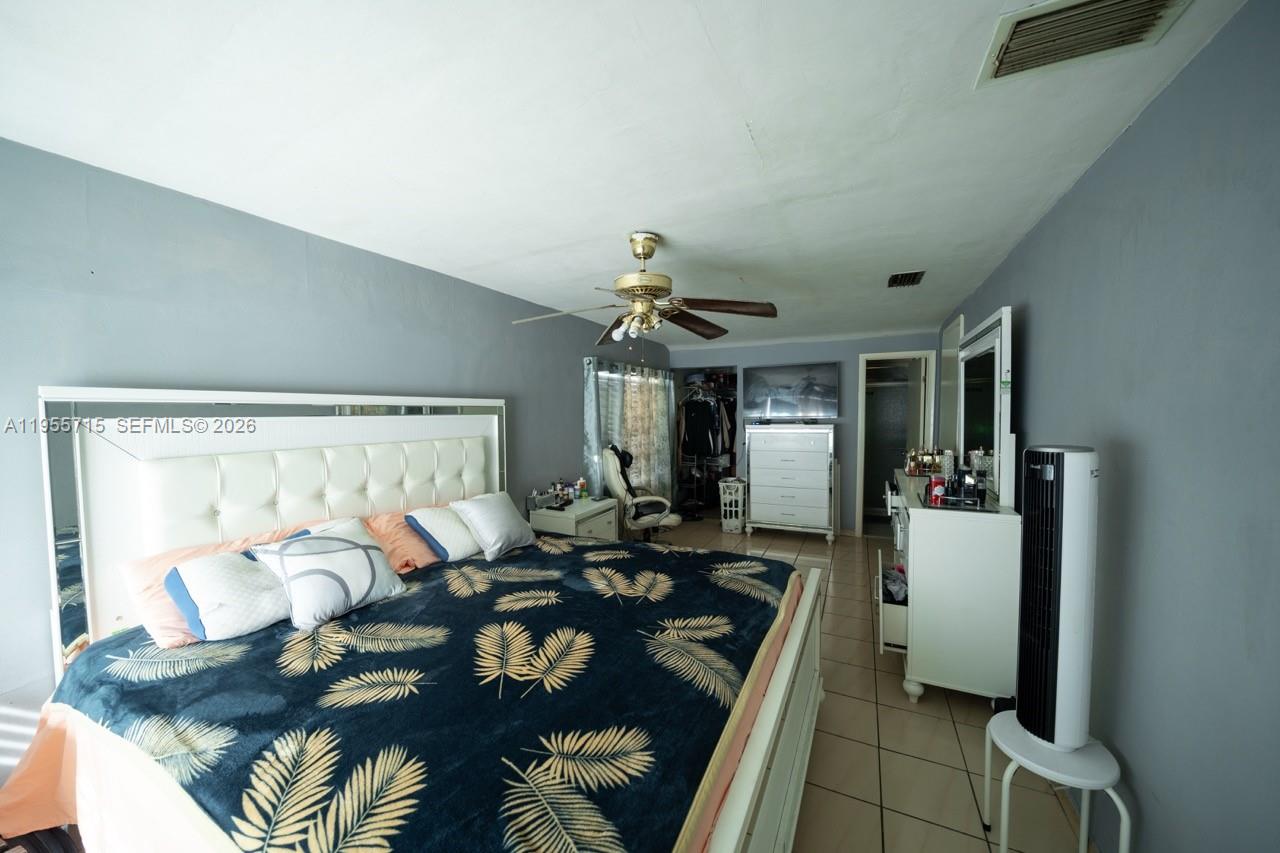 671 East 6th Place Hialeah, FL 33010 - Photo 16 of 40 a living room with furniture and a chandelier