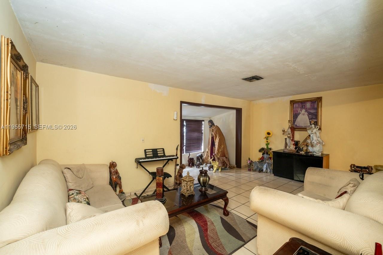 671 East 6th Place Hialeah, FL 33010 - Photo 18 of 40 a living room with furniture and a large window
