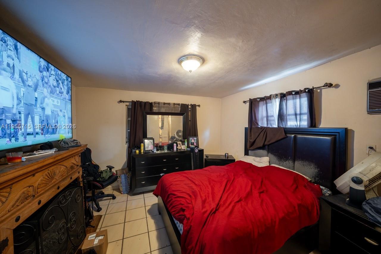 671 East 6th Place Hialeah, FL 33010 - Photo 25 of 40 a bed room with a bed and furniture