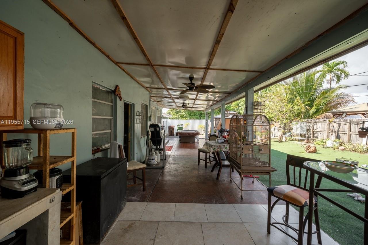 671 East 6th Place Hialeah, FL 33010 - Photo 28 of 40 a view of a dining room with furniture a chandelier and fireplace