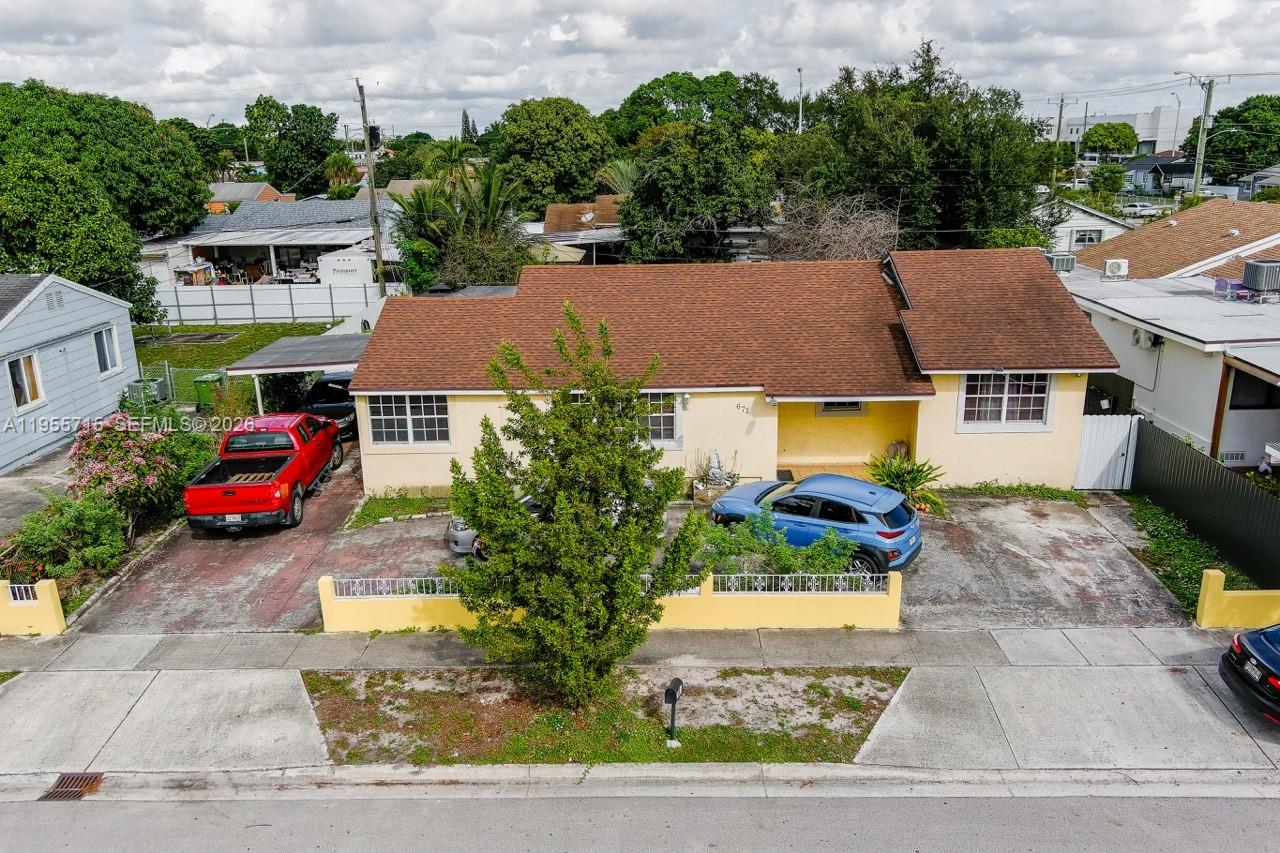 671 East 6th Place Hialeah, FL 33010 - Photo 36 of 40 a aerial view of a house with a yard and a car park side