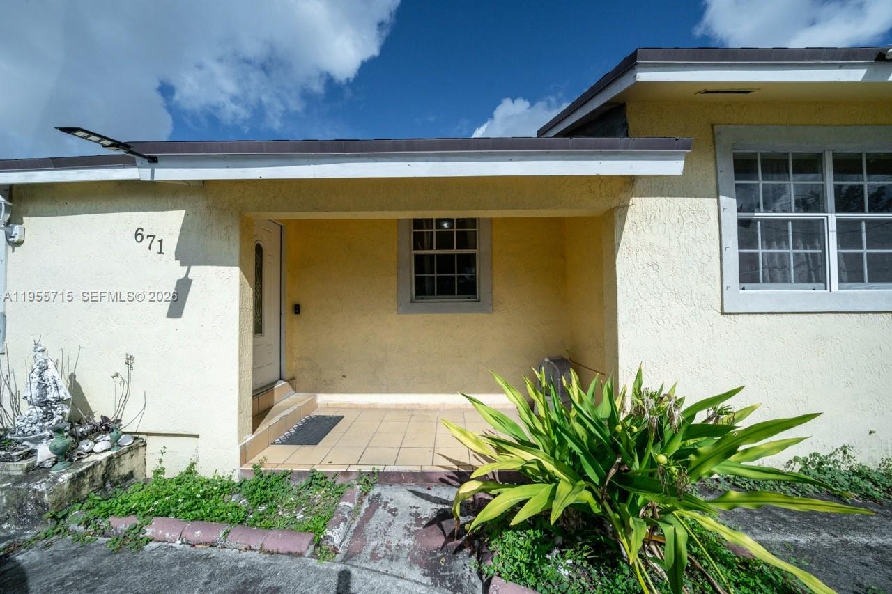 671 East 6th Place Hialeah, FL 33010 - Photo 5 of 40 a front view of a house with a yard