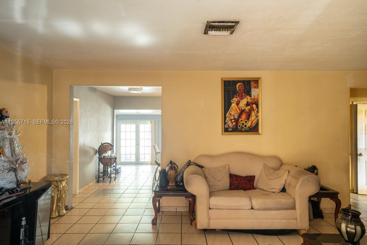 671 East 6th Place Hialeah, FL 33010 - Photo 7 of 40 a living room with furniture and a mirror