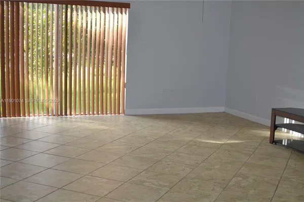 a bathroom with a window a toilet and a shower