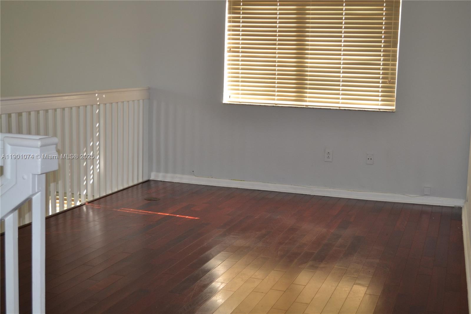 22418 Southwest 94th Path Cutler Bay, FL 33190 - Photo 18 of 71 an empty room with wooden floor and a window