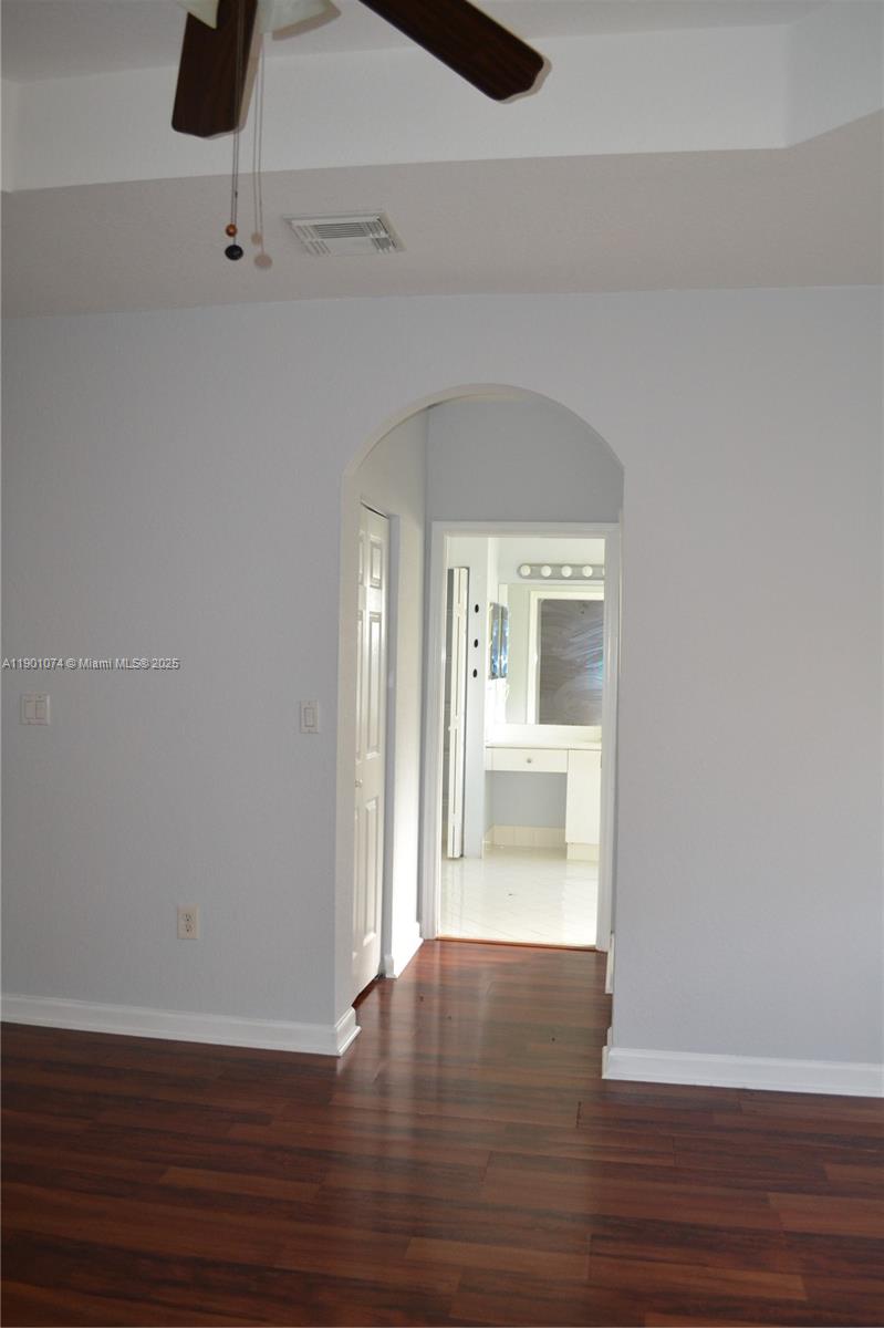 22418 Southwest 94th Path Cutler Bay, FL 33190 - Photo 26 of 71 a view of an empty room with wooden floor and a window