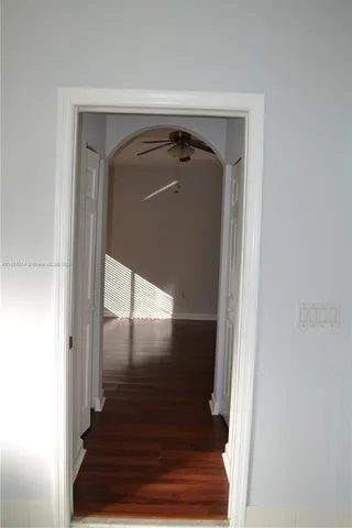a view of staircase with white walls and a window