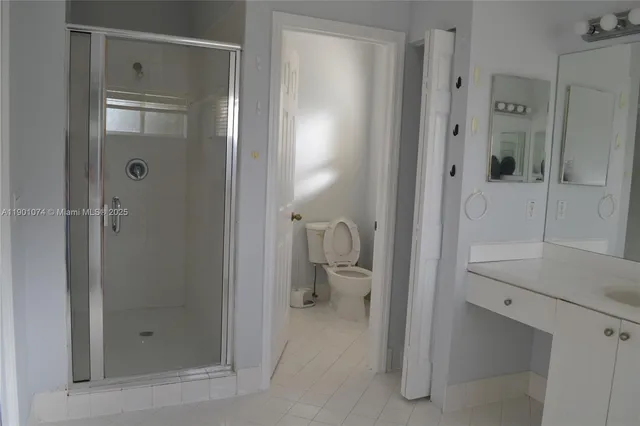 a bathroom with a toilet a sink and a window