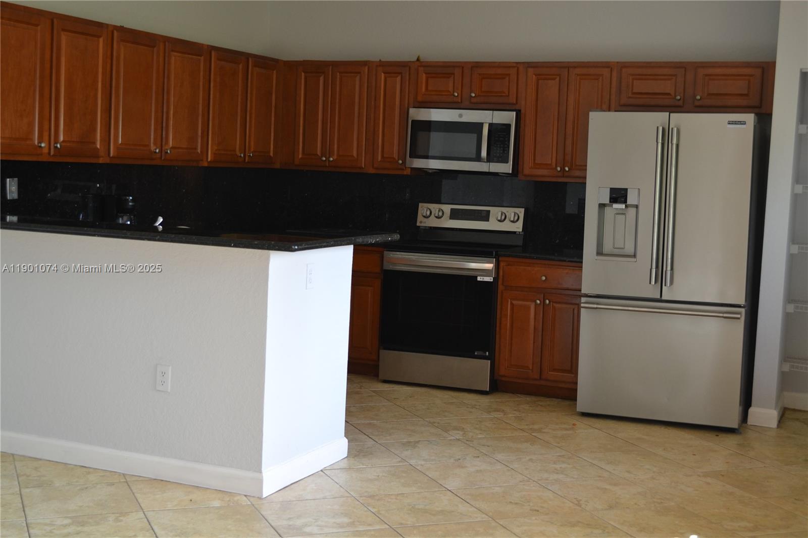 22418 Southwest 94th Path Cutler Bay, FL 33190 - Photo 3 of 71 a kitchen with a refrigerator stove and microwave