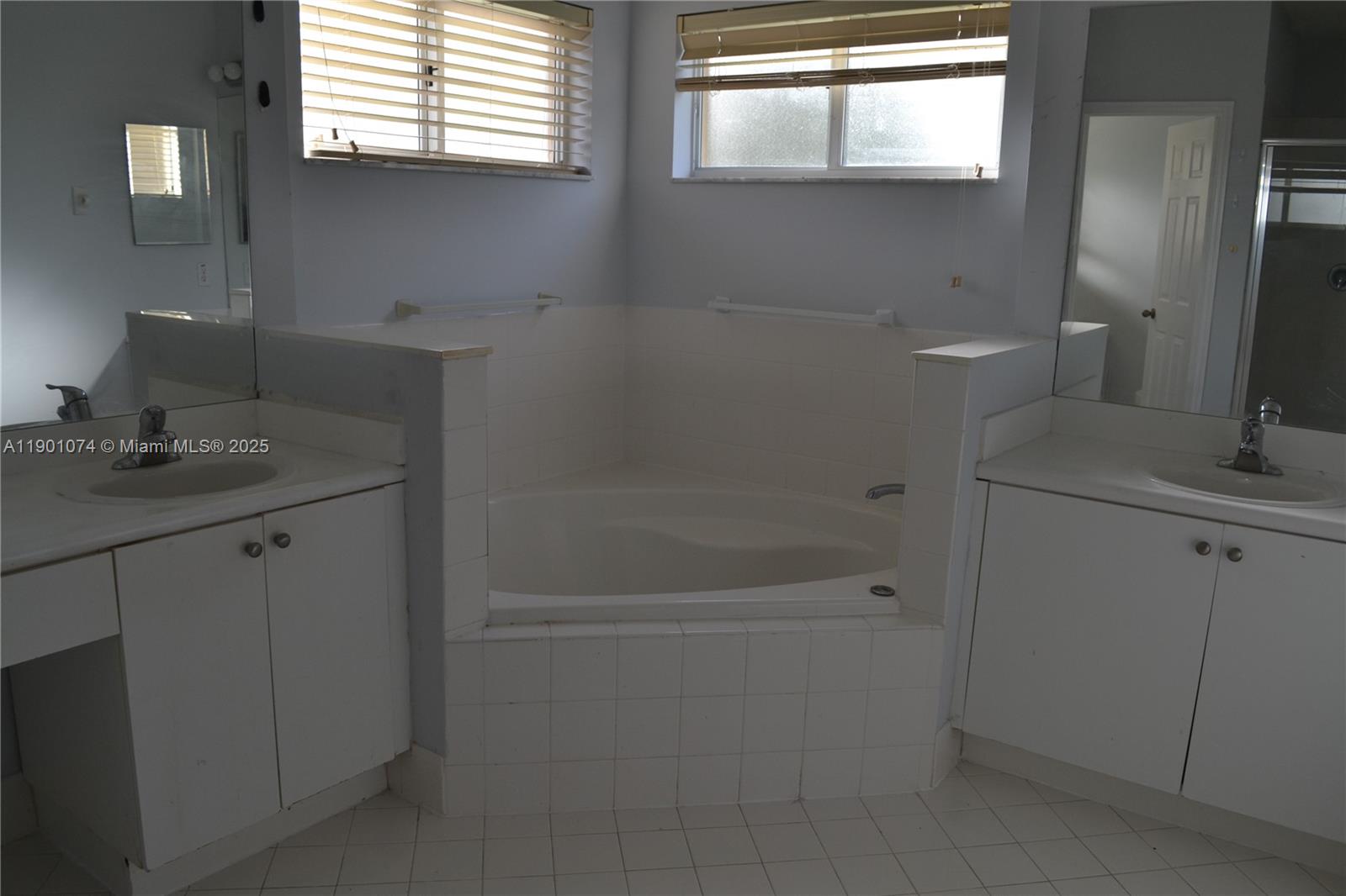 22418 Southwest 94th Path Cutler Bay, FL 33190 - Photo 31 of 71 a bathroom with a granite countertop sink a shower and a mirror