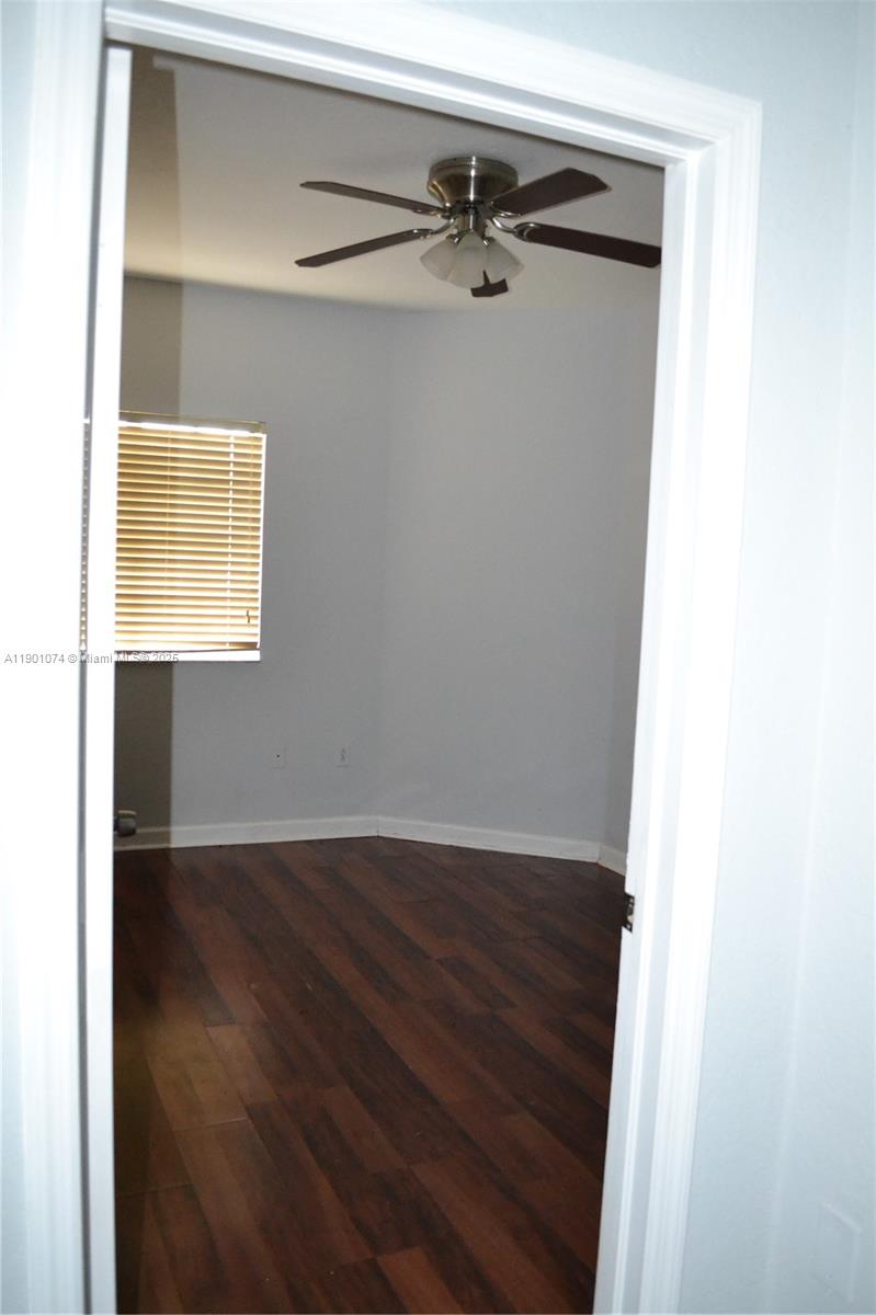 22418 Southwest 94th Path Cutler Bay, FL 33190 - Photo 34 of 71 a view of a room with wooden floor and a window