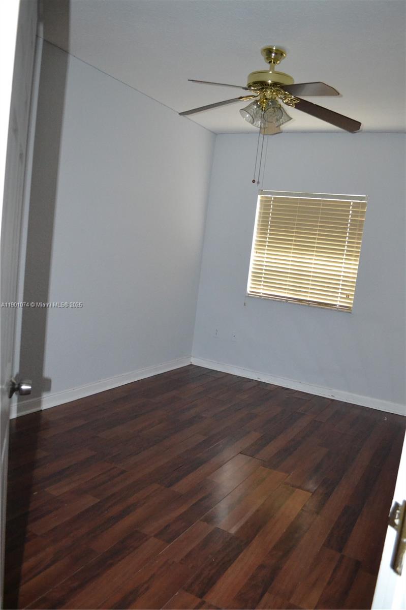22418 Southwest 94th Path Cutler Bay, FL 33190 - Photo 35 of 71 a view of room with a ceiling fan and wooden floor