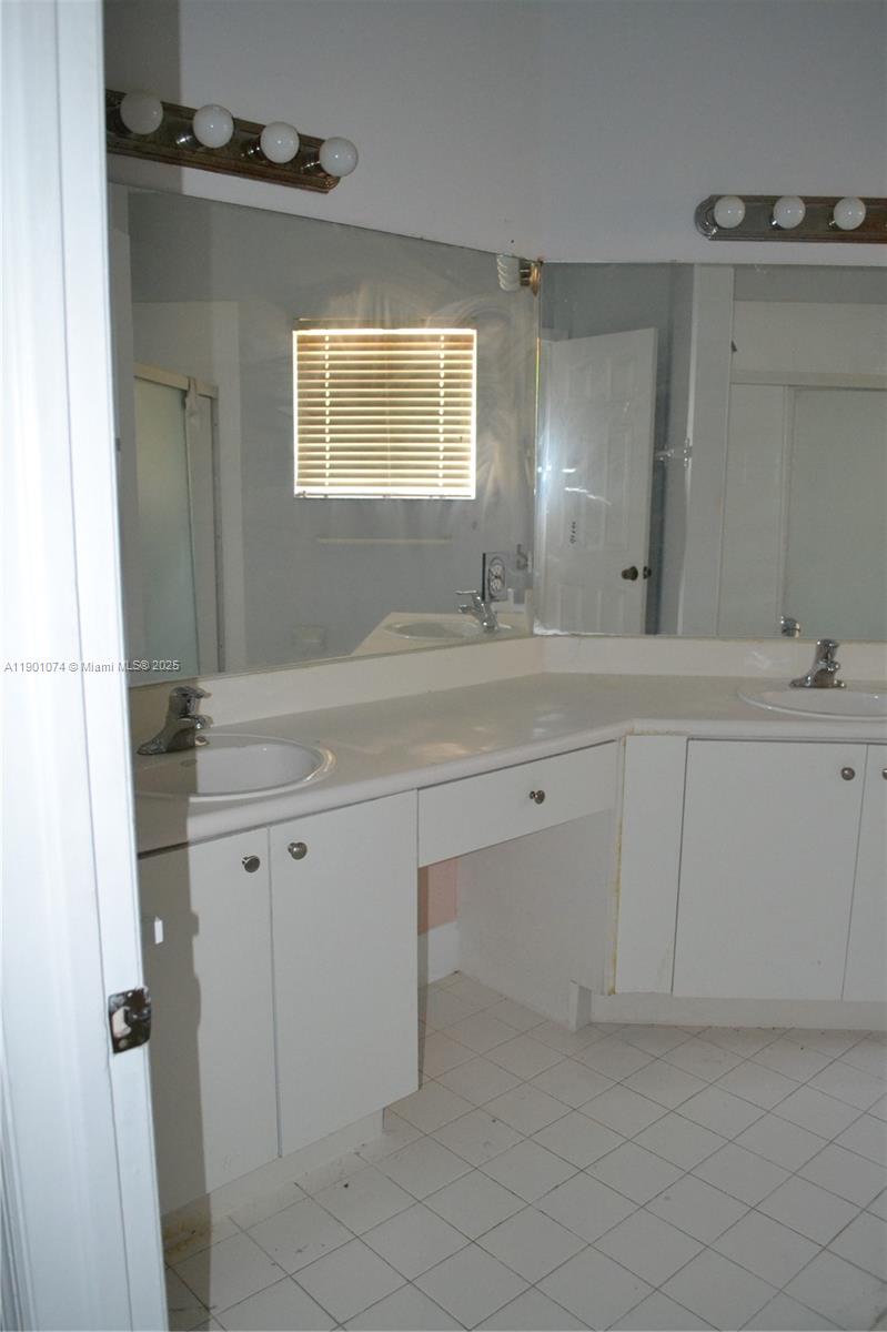 22418 Southwest 94th Path Cutler Bay, FL 33190 - Photo 38 of 71 a sink with white cabinets