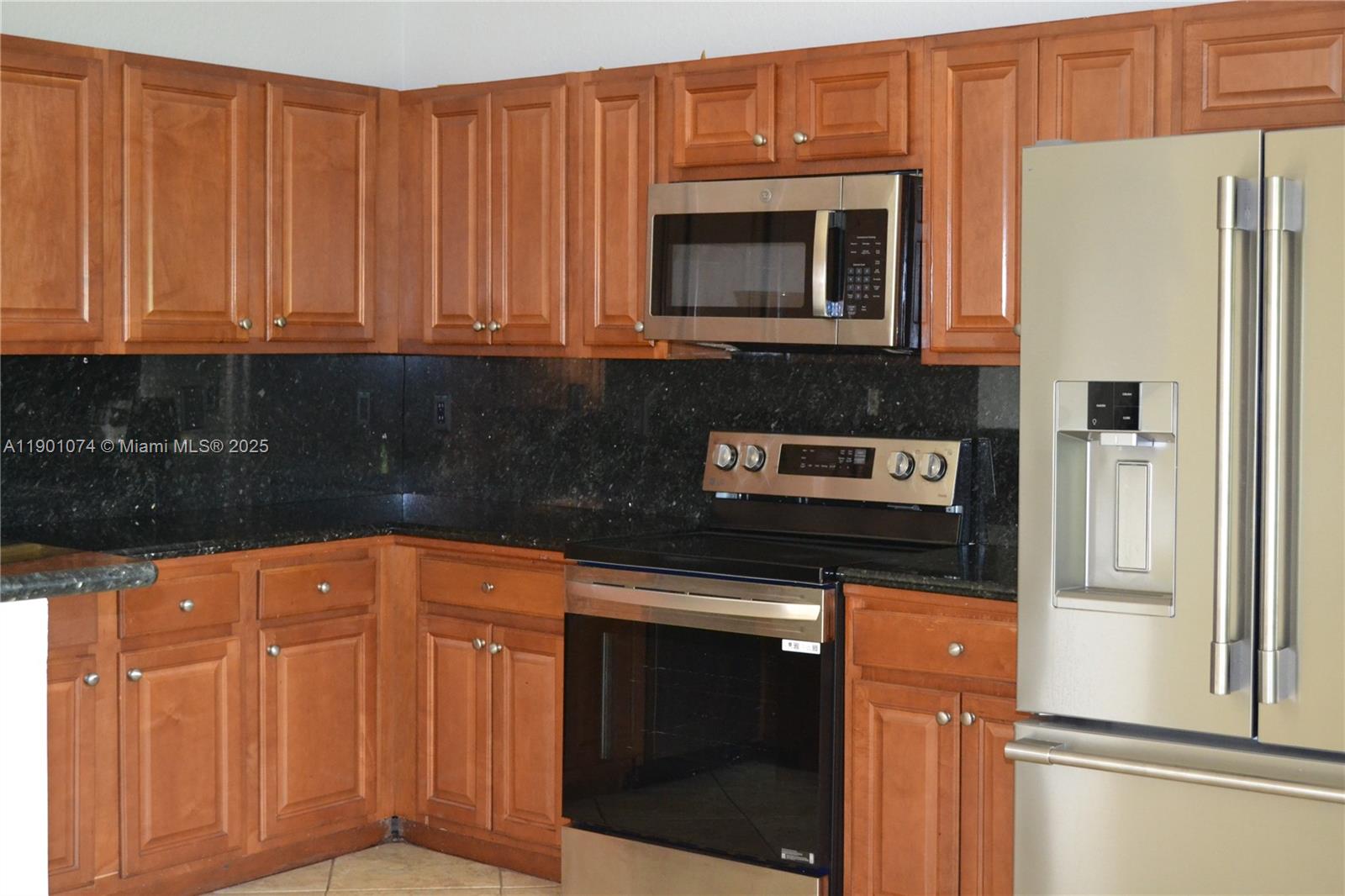 22418 Southwest 94th Path Cutler Bay, FL 33190 - Photo 5 of 71 a kitchen with stainless steel appliances granite countertop a refrigerator and a stove top oven