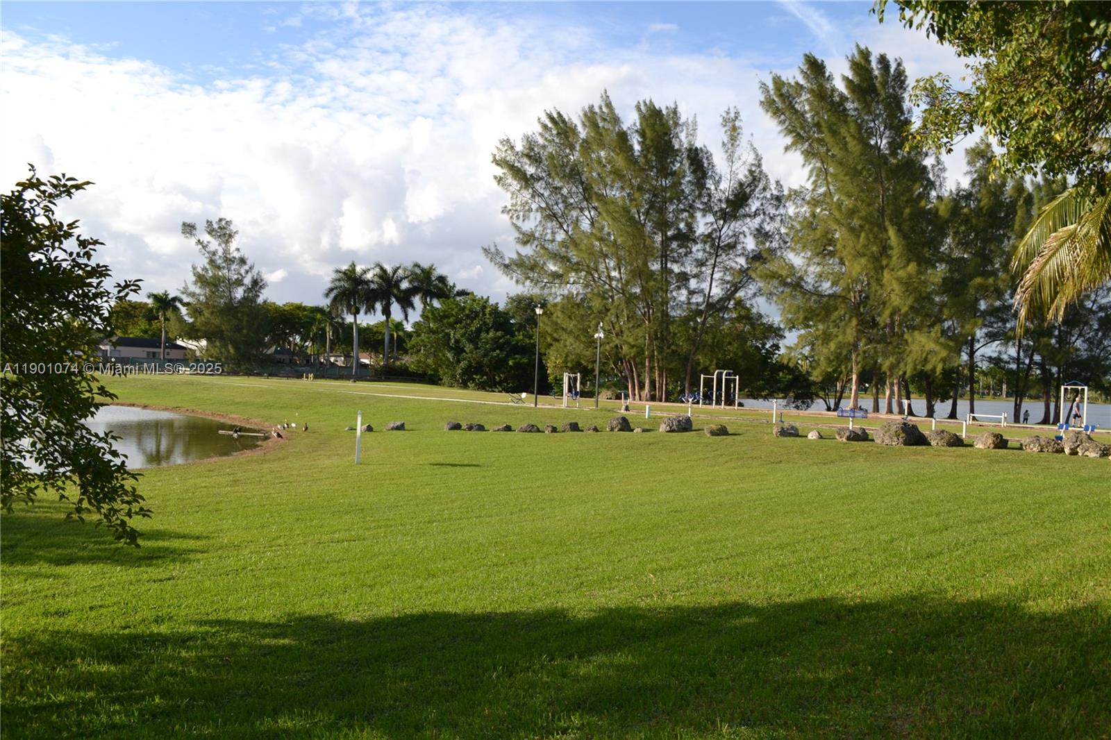 22418 Southwest 94th Path Cutler Bay, FL 33190 - Photo 51 of 71 a view of a golf course with a lake