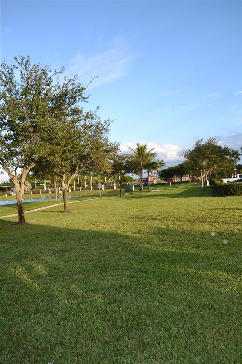 22418 Southwest 94th Path Cutler Bay, FL 33190 - Photo 71 of 71 a view of grassy field with benches