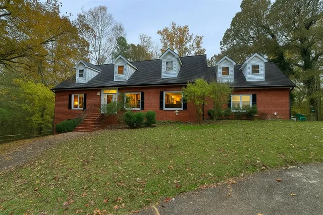 a front view of house with yard and green space
