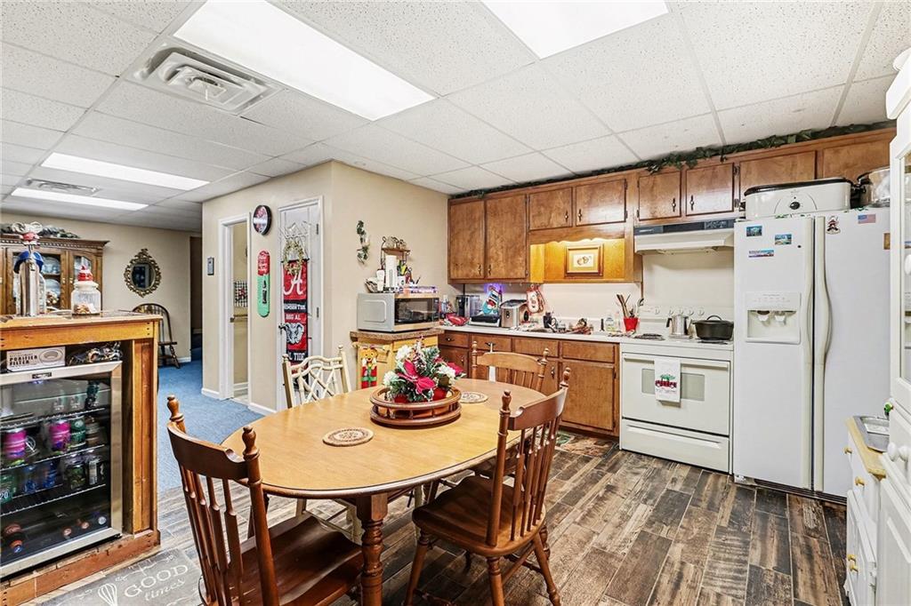 7537 Berea Road Winston, GA 30187 - Photo 23 of 34 a kitchen with stainless steel appliances a dining table chairs refrigerator and sink