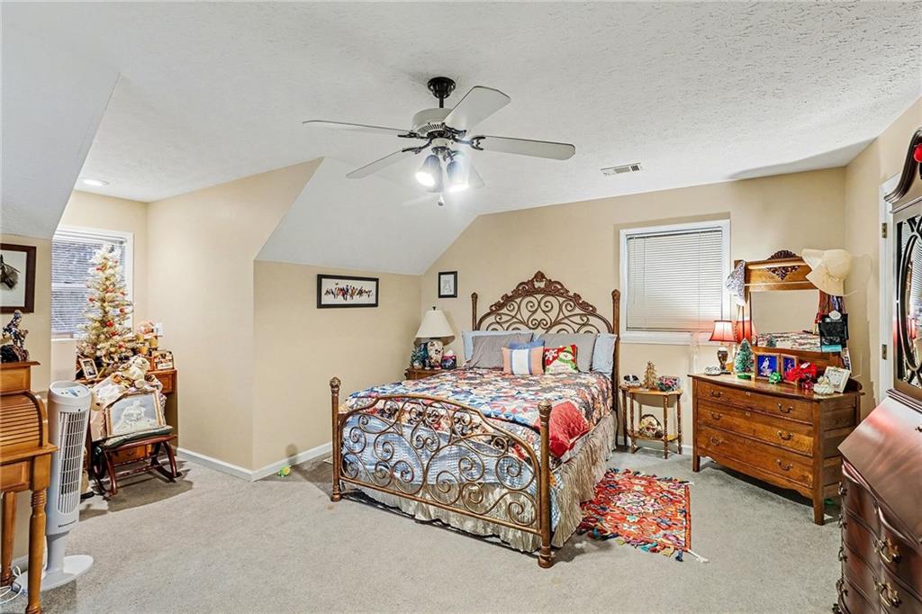7537 Berea Road Winston, GA 30187 - Photo 25 of 37 a bedroom with a bed and a lamp