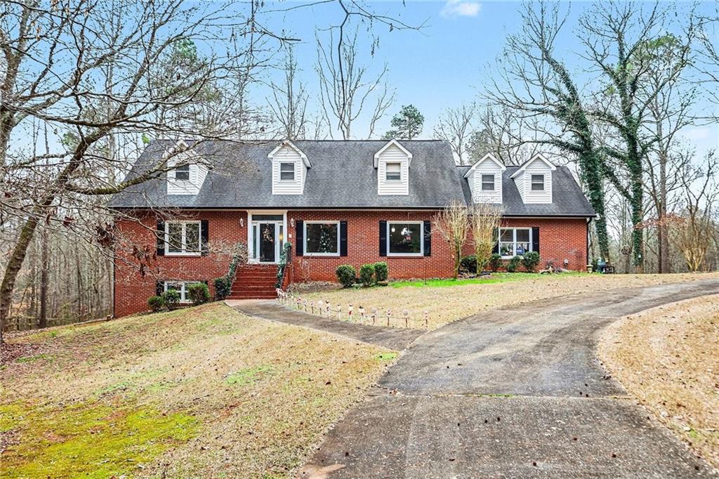 7537 Berea Road Winston, GA 30187 - Photo 4 of 37 a front view of a house with a yard covered with snow and trees