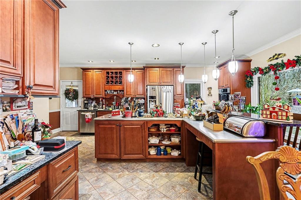 7537 Berea Road Winston, GA 30187 - Photo 7 of 34 a view of a kitchen with kitchen island stainless steel appliances a stove and a table