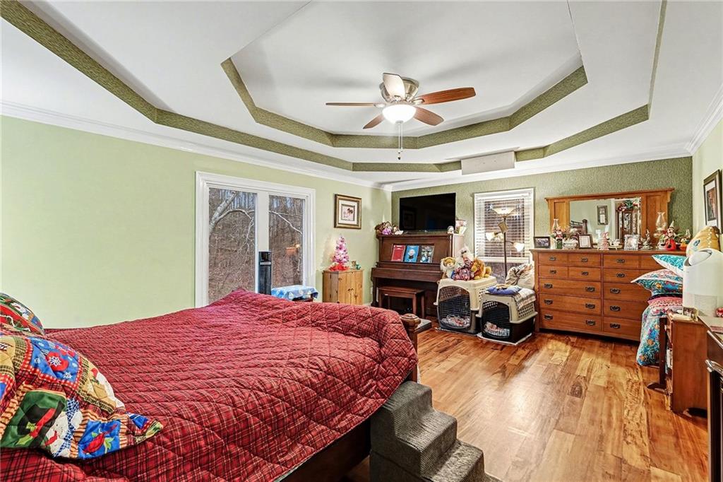 7537 Berea Road Winston, GA 30187 - Photo 10 of 34 a bed room with a bed mirror and a ceiling fan