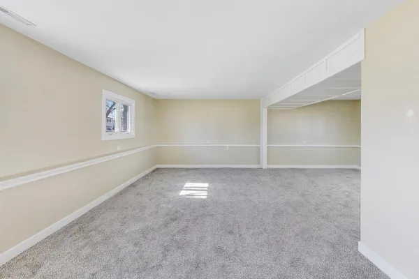 an empty room with a empty space and window