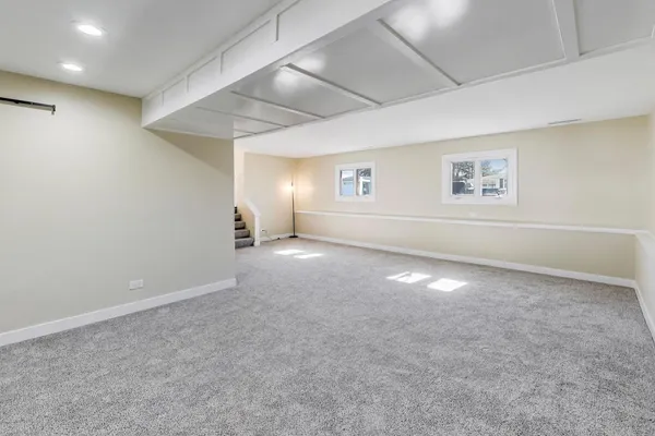 an empty room with a empty space and windows