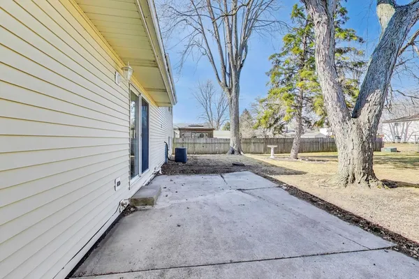 a view of a house with a tree and a yard