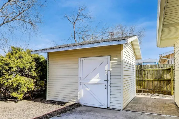a view of a house with a door and wooden walls