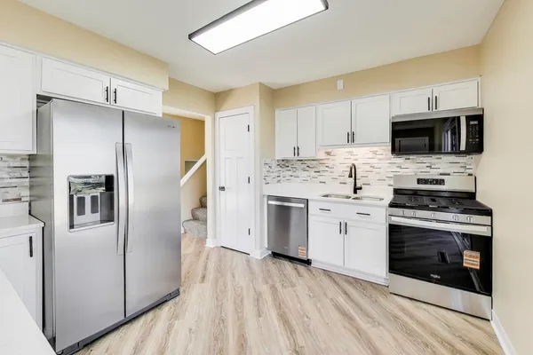 a kitchen with a microwave stove top oven and refrigerator