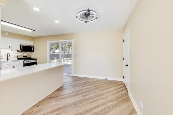 a large white kitchen with a large window