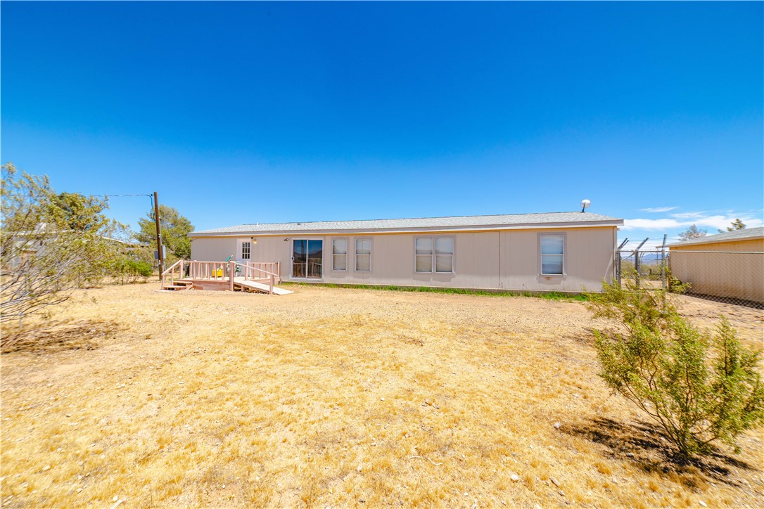 4729 Stewart Mountain Road Golden Valley, AZ 86413 - Photo 20 of 28 a backyard of a house with a yard