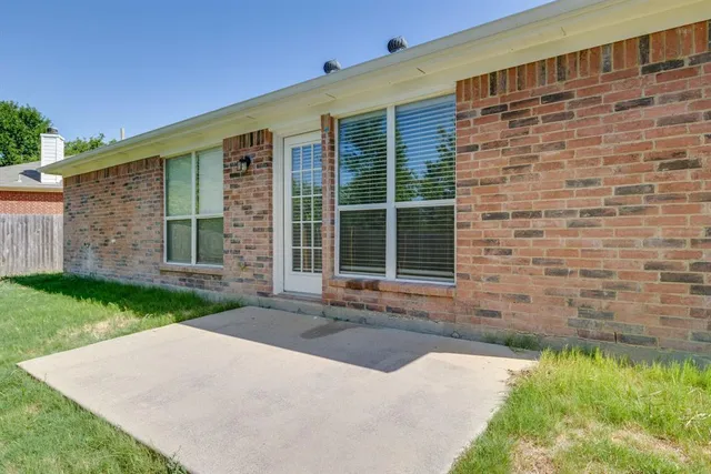 a view of small yard with wooden fence