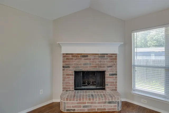 a living room with a fireplace and a fireplace