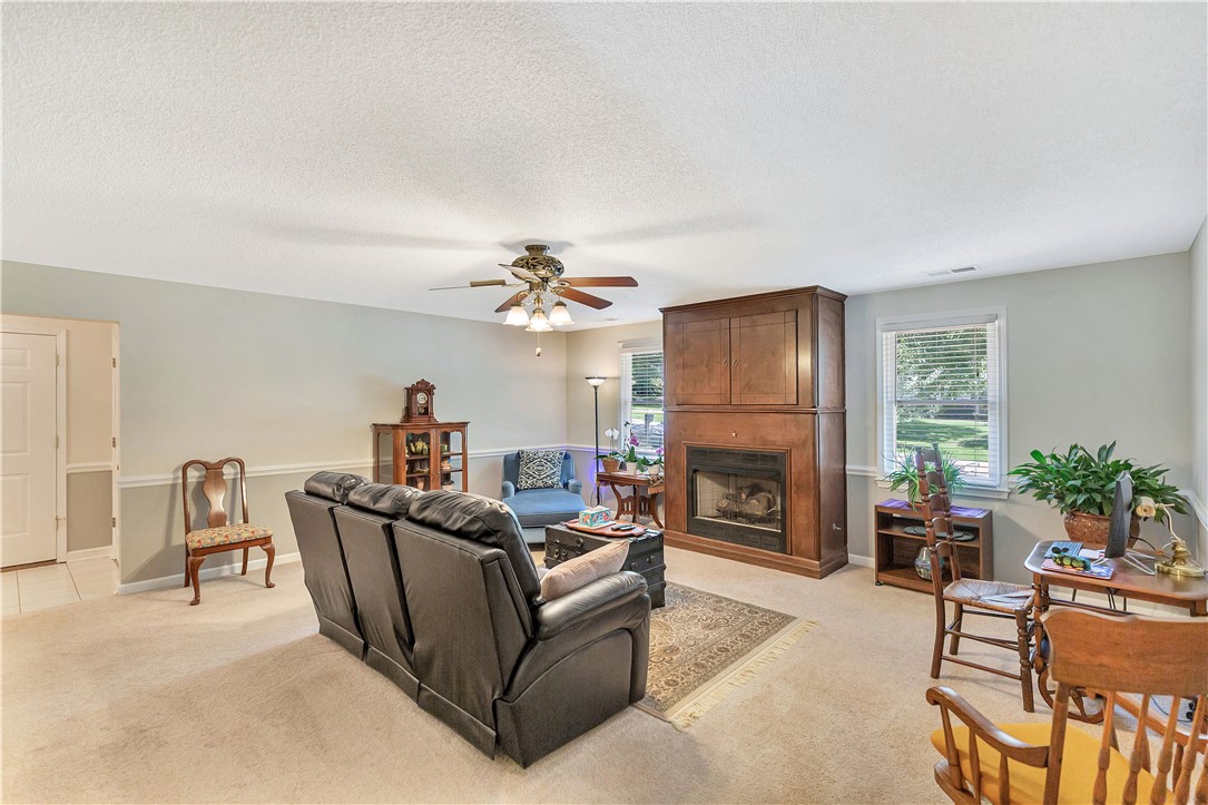 910 Chantilly Lane Anderson, SC 29625 - Photo 26 of 38 A comforting living room provides an inviting atmosphere, complete with a hearth and a ceiling fan.