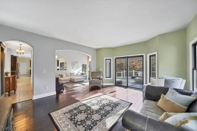 a dining room with furniture a livingroom and chandelier