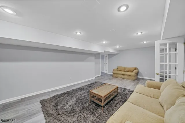 a living room with furniture and couches with kitchen view