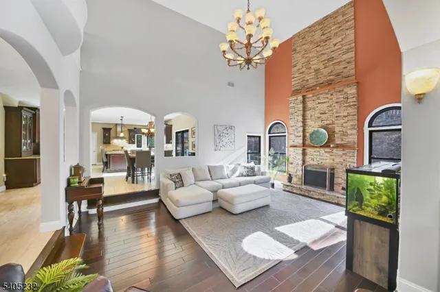 a living room with fireplace furniture and a wooden floor