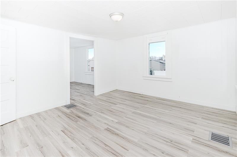 336 Walkchalk Road Kittanning, PA 16201 - Photo 16 of 49 an empty room with wooden floor and windows