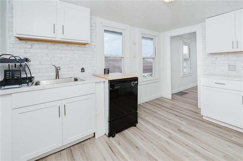 336 Walkchalk Road Kittanning, PA 16201 - Photo 19 of 49 a kitchen with a sink a stove cabinets and wooden floor