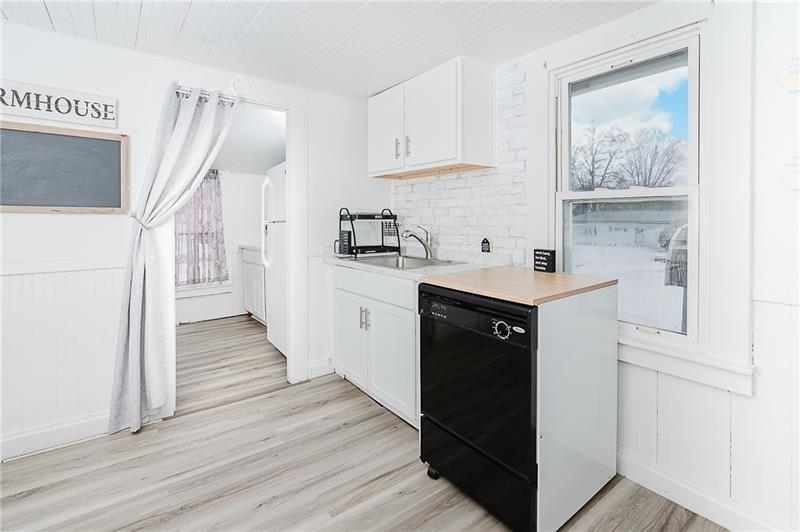 336 Walkchalk Road Kittanning, PA 16201 - Photo 24 of 49 a kitchen with stainless steel appliances granite countertop a refrigerator a sink and white cabinets