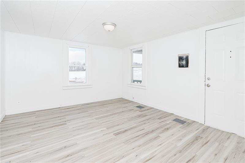 336 Walkchalk Road Kittanning, PA 16201 - Photo 9 of 49 an empty room with wooden floor and windows