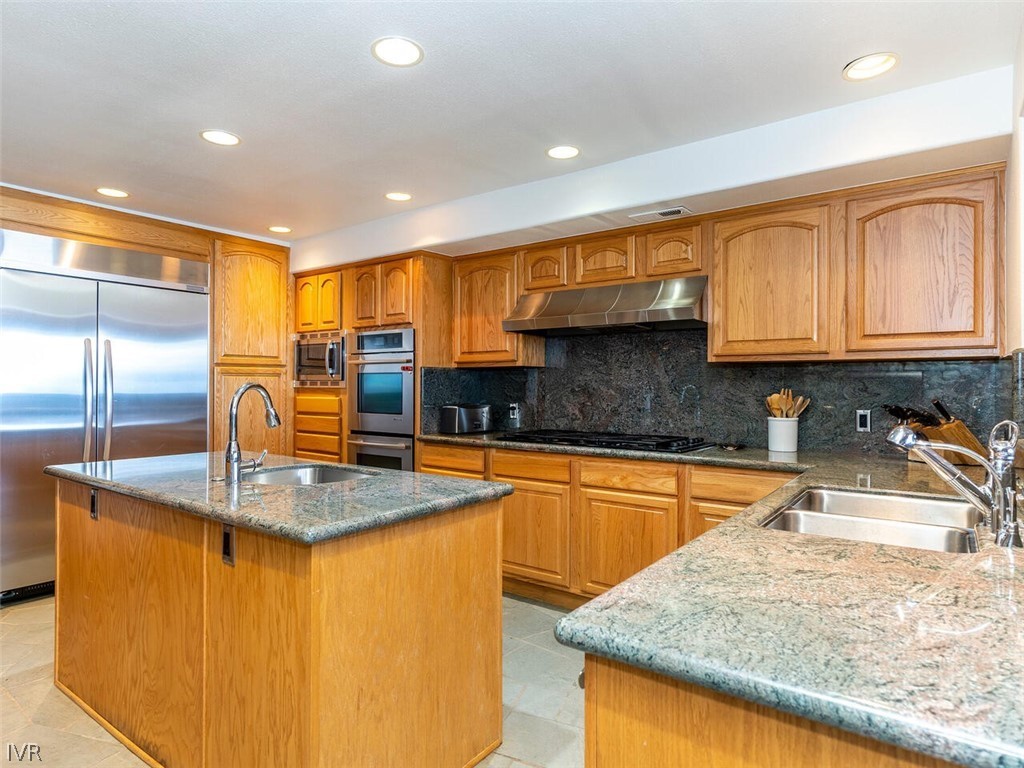 949 Lakeshore Boulevard Incline Village, NV 89451 - Photo 14 of 33 a kitchen with stainless steel appliances granite countertop sink stove and refrigerator