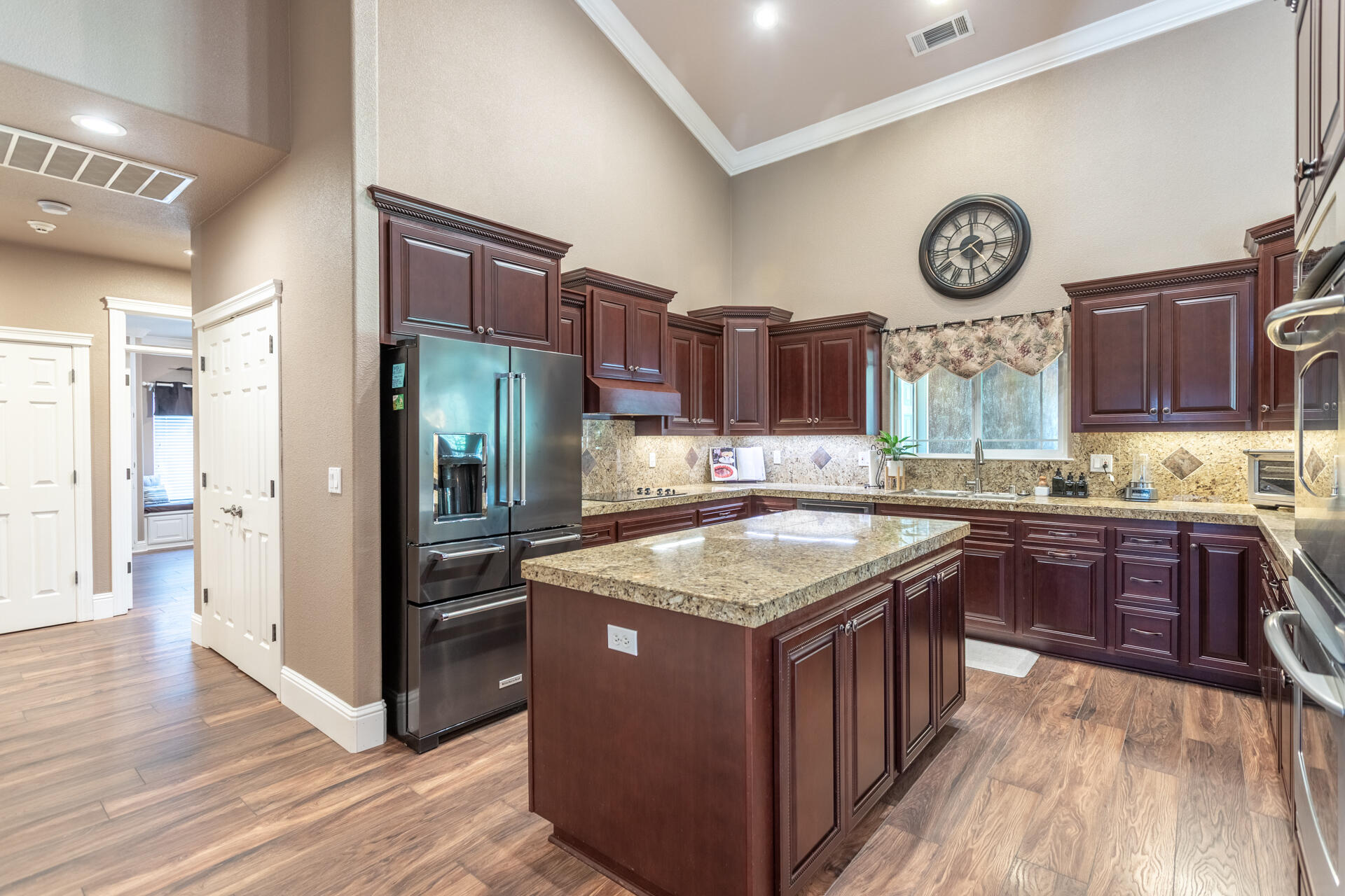 7307 Del Rico Court Palo Cedro, CA 96073 - Photo 12 of 55 a kitchen with stainless steel appliances granite countertop a stove a refrigerator a sink and dishwasher with wooden floor