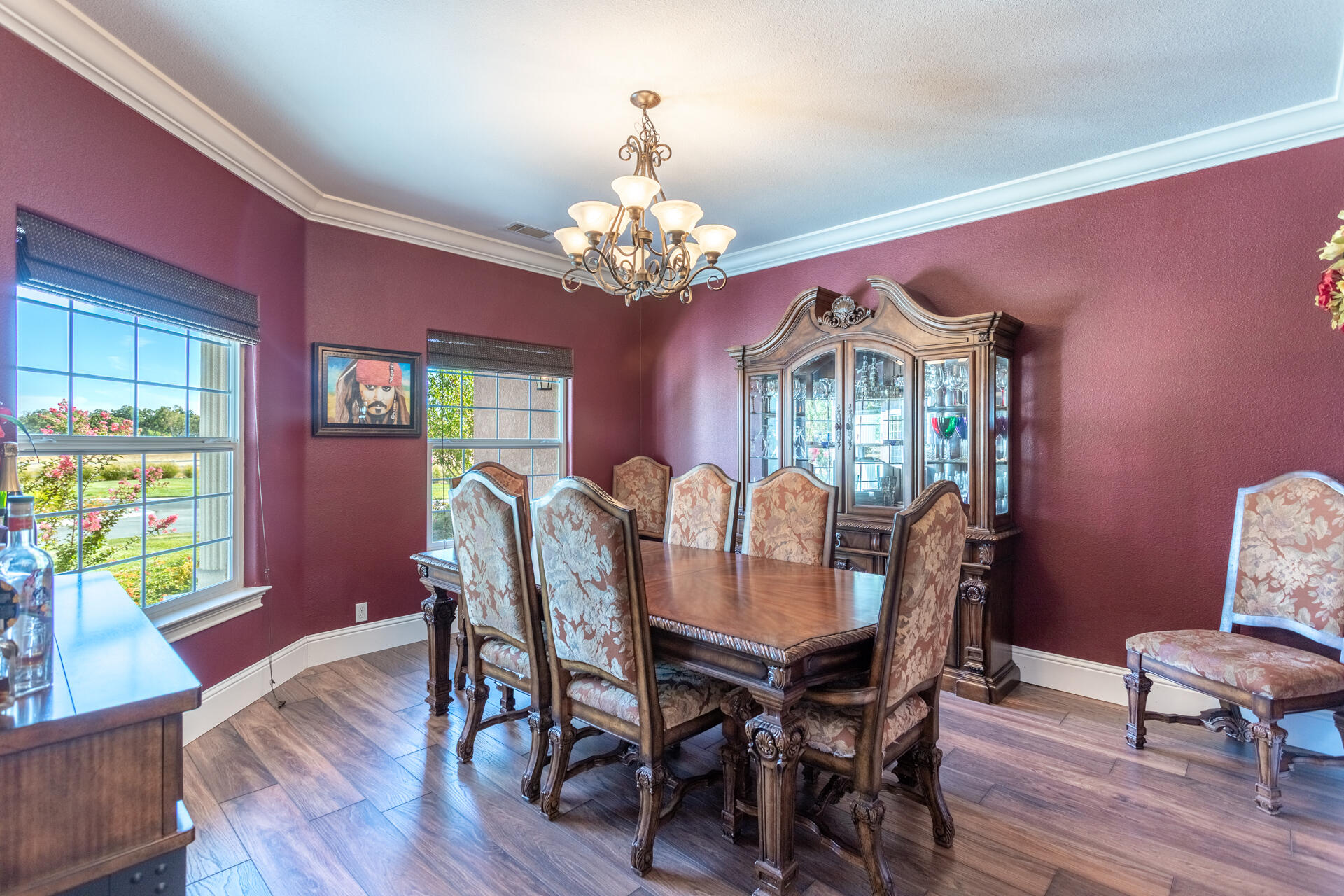 7307 Del Rico Court Palo Cedro, CA 96073 - Photo 16 of 55 a view of a dining room with furniture a chandelier and wooden floor