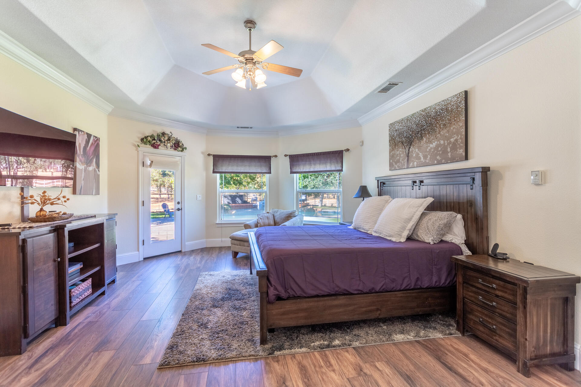 7307 Del Rico Court Palo Cedro, CA 96073 - Photo 17 of 55 a bedroom with a bed and a chandelier