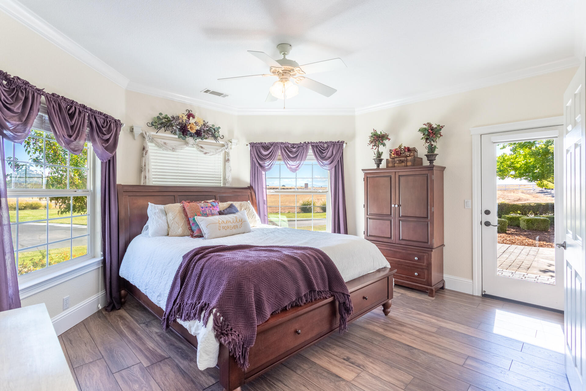 7307 Del Rico Court Palo Cedro, CA 96073 - Photo 24 of 55 a bedroom with a large bed and a chandelier